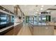 Open concept kitchen boasts a large island, stainless steel appliances, and hardwood floors at 1210 Blue Shell Loop, Sarasota, FL 34240