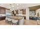 Modern kitchen with a large island, stainless steel appliances, and light wood floors at 1210 Blue Shell Loop, Sarasota, FL 34240