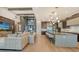 Open floor plan living room with large sectional sofa and wood feature wall at 1210 Blue Shell Loop, Sarasota, FL 34240