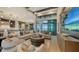 Spacious living room with water views, large sectional sofa, and wood flooring at 1210 Blue Shell Loop, Sarasota, FL 34240