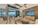 Bright living room featuring a sectional sofa, water views, and a wood accent wall at 1210 Blue Shell Loop, Sarasota, FL 34240