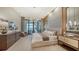 Luxurious main bedroom with water views and sitting area at 1210 Blue Shell Loop, Sarasota, FL 34240