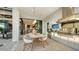 Modern outdoor kitchen with stainless steel appliances and dining area at 1210 Blue Shell Loop, Sarasota, FL 34240