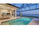 Covered outdoor kitchen with pool and water views at 1210 Blue Shell Loop, Sarasota, FL 34240
