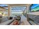 Covered patio with fireplace and lake view at 1210 Blue Shell Loop, Sarasota, FL 34240