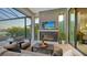 Covered patio with fireplace and lake view at 1210 Blue Shell Loop, Sarasota, FL 34240