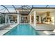 Relaxing pool and patio oasis with outdoor kitchen and comfortable seating at 1210 Blue Shell Loop, Sarasota, FL 34240