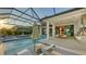 Resort-style pool and patio with outdoor kitchen and covered seating area at 1210 Blue Shell Loop, Sarasota, FL 34240