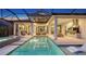 Stunning nighttime view of the pool and patio area at 1210 Blue Shell Loop, Sarasota, FL 34240