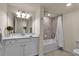 Updated bathroom with tub, shower, and white vanity at 12550 Ghiberti Cir # 101, Venice, FL 34293