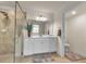 Bathroom with walk-in shower, vanity with storage, and toilet at 12550 Ghiberti Cir # 101, Venice, FL 34293