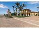 Impressive community entrance with palm trees and brickwork at 12550 Ghiberti Cir # 101, Venice, FL 34293