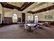 Bright community room with tables and chairs for gatherings at 12550 Ghiberti Cir # 101, Venice, FL 34293