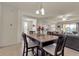 Dining area with dark wood table and chairs, view of living room at 12550 Ghiberti Cir # 101, Venice, FL 34293