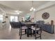Dining area with dark wood table and chairs, view of living room at 12550 Ghiberti Cir # 101, Venice, FL 34293