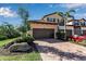 Two-story townhome with paver driveway, landscaping, and two-car garage at 12550 Ghiberti Cir # 101, Venice, FL 34293