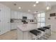 Modern kitchen with white cabinets and a large island at 12550 Ghiberti Cir # 101, Venice, FL 34293