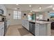 Bright kitchen features white cabinets and a breakfast bar at 12550 Ghiberti Cir # 101, Venice, FL 34293