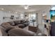Open concept living room with access to a patio and kitchen at 12550 Ghiberti Cir # 101, Venice, FL 34293