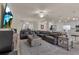 Spacious living room with a large sectional sofa and TV at 12550 Ghiberti Cir # 101, Venice, FL 34293
