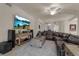 Relaxing living room featuring a sectional sofa and large TV at 12550 Ghiberti Cir # 101, Venice, FL 34293