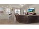 Open living room with large sectional sofa and flat screen TV at 12550 Ghiberti Cir # 101, Venice, FL 34293