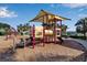 playground with play structures and shaded areas at 12550 Ghiberti Cir # 101, Venice, FL 34293