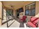 Enjoy this screened lanai with comfortable seating and a TV at 12550 Ghiberti Cir # 101, Venice, FL 34293