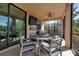 Relaxing screened lanai with table, chairs, and ceiling fan at 12550 Ghiberti Cir # 101, Venice, FL 34293