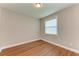 Simple bedroom with wood-look floors and window at 15520 High Bell Pl, Bradenton, FL 34212