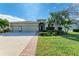 Two-story house with three-car garage, landscaped yard, and brick walkway at 15520 High Bell Pl, Bradenton, FL 34212