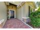 Front entry with black door, brick walkway, and potted plants at 15520 High Bell Pl, Bradenton, FL 34212