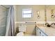 Bathroom with granite vanity, shower, and tiled walls at 1737 Bonitas Cir # 1724D, Venice, FL 34293