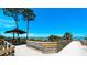 Wooden boardwalk leads to a sandy beach with ocean views at 1737 Bonitas Cir # 1724D, Venice, FL 34293