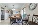 Dining area with dark wood table and chairs, near kitchen at 1737 Bonitas Cir # 1724D, Venice, FL 34293
