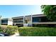 Exterior view of condo building with landscaping and balcony at 1737 Bonitas Cir # 1724D, Venice, FL 34293