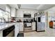 Kitchen features white cabinets, granite counters and stainless appliances at 1737 Bonitas Cir # 1724D, Venice, FL 34293