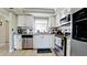 Kitchen boasts white cabinets, granite countertops, and stainless steel appliances at 1737 Bonitas Cir # 1724D, Venice, FL 34293