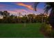Spacious backyard with lush lawn, providing a peaceful outdoor space at 176 Avens Dr, Nokomis, FL 34275