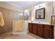 Bathroom with walk-in shower, tiled walls, and double vanity at 176 Avens Dr, Nokomis, FL 34275
