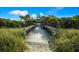 Boardwalk leads to beach pavilion, offering shade at 176 Avens Dr, Nokomis, FL 34275