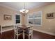 Bright dining room with a wooden table and four chairs at 176 Avens Dr, Nokomis, FL 34275