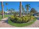 Vibrant park with palm trees, lush greenery, and a brick pathway at 176 Avens Dr, Nokomis, FL 34275