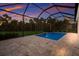 Enclosed pool with water feature at sunset at 176 Avens Dr, Nokomis, FL 34275