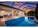 Enclosed pool with water feature at sunset at 176 Avens Dr, Nokomis, FL 34275