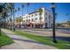 Scenic street view with palm trees, grass, and a row of buildings at 176 Avens Dr, Nokomis, FL 34275