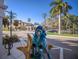 Scenic street view with palm trees and unique artistic displays at 176 Avens Dr, Nokomis, FL 34275