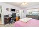 Bedroom featuring wood-look floors, closet, desk, and relaxing ambiance at 2102 Alaric St, Port Charlotte, FL 33952