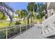Outdoor balcony with stairs leading down to the landscaped grounds at 250 Sands Point Rd # 5105, Longboat Key, FL 34228