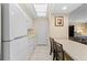 Efficient galley kitchen with white appliances and ample counter space at 250 Sands Point Rd # 5105, Longboat Key, FL 34228